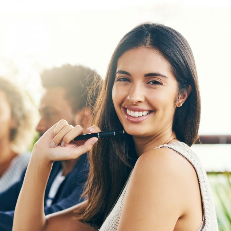 Portrait of a young businesswoman having a meeting with her colleagues outdoors