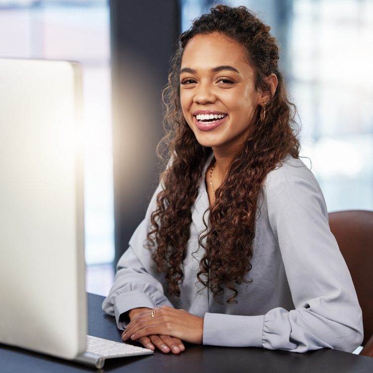 So proud of my business acumen. Shot of a young businesswoman working on her computer at work.